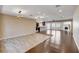 Spacious living room featuring an open layout with hardwood floors and a kitchen view at 6117 Foxcroft Ave, Las Vegas, NV 89108