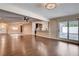 Living room featuring an open layout with hardwood floors, a kitchen view, and a ceiling fan at 6117 Foxcroft Ave, Las Vegas, NV 89108