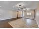 Open-concept living room with raised tile sitting area and dark-wood flooring at 6117 Foxcroft Ave, Las Vegas, NV 89108