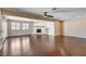 Spacious living room featuring hardwood floors, a fireplace, and plenty of natural light at 6117 Foxcroft Ave, Las Vegas, NV 89108