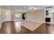 Open-concept living room with unique flooring and modern light fixtures at 6117 Foxcroft Ave, Las Vegas, NV 89108