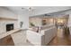 Spacious living room with fireplace, hardwood floors, and bar seating area at 6117 Foxcroft Ave, Las Vegas, NV 89108