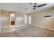 Bright main bedroom with a ceiling fan and an exterior exit door leading to the back yard at 6117 Foxcroft Ave, Las Vegas, NV 89108