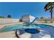 Sparkling pool with a slide and spa, surrounded by an enclosed fence and a shed at 6117 Foxcroft Ave, Las Vegas, NV 89108