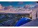 Panoramic aerial view of an upscale neighborhood featuring a luxurious home and infinity pool at 621 Majestic Rim Dr, Henderson, NV 89012
