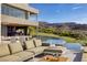 Backyard featuring a large infinity pool, patio seating, and a golf course view with mountain backdrop at 621 Majestic Rim Dr, Henderson, NV 89012