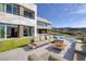 Modern home backyard featuring a large infinity pool, patio seating, and a golf course view at 621 Majestic Rim Dr, Henderson, NV 89012