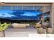Relaxing outdoor patio with comfortable seating, lush landscaping, and city views at twilight at 621 Majestic Rim Dr, Henderson, NV 89012
