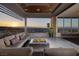 Inviting balcony with comfortable seating and a modern fire pit, overlooking the city skyline at sunset at 621 Majestic Rim Dr, Henderson, NV 89012