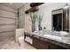 Modern bathroom boasting double sinks, a walk-in shower, and stylish decor with wood-look tile at 621 Majestic Rim Dr, Henderson, NV 89012