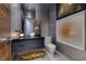 Contemporary bathroom featuring stone accents, unique artwork, and high-end fixtures at 621 Majestic Rim Dr, Henderson, NV 89012