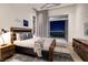 Stylishly furnished bedroom with a view of the city skyline from the outdoor terrace at 621 Majestic Rim Dr, Henderson, NV 89012