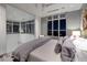 Comfortable modern bedroom with city views from large windows and connected glass enclosed office space at 621 Majestic Rim Dr, Henderson, NV 89012