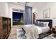 Comfortable bedroom featuring a large window with views, stylish decor, and a modern aesthetic at 621 Majestic Rim Dr, Henderson, NV 89012
