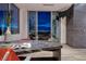 Elegant dining room with a marble table, designer chairs, and stunning city views at 621 Majestic Rim Dr, Henderson, NV 89012