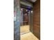 Modern home elevator featuring wood paneling and stainless steel accents for convenient access at 621 Majestic Rim Dr, Henderson, NV 89012