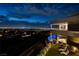 Contemporary home featuring a lush backyard, private pool, and breathtaking city views at 621 Majestic Rim Dr, Henderson, NV 89012