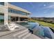 Luxury backyard showcasing tiered infinity pool, sleek lounge chairs, and stunning golf course views at 621 Majestic Rim Dr, Henderson, NV 89012