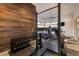 Home gym featuring weights, squat rack and cardio equipment with natural light and wood accent wall at 621 Majestic Rim Dr, Henderson, NV 89012