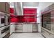 Chef's kitchen featuring high-end stainless steel appliances, vibrant red backsplash, and modern cabinetry at 621 Majestic Rim Dr, Henderson, NV 89012