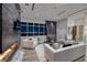 Stylish living area with a linear fireplace, comfortable seating, and an impressive city skyline view at 621 Majestic Rim Dr, Henderson, NV 89012