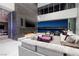 Modern living room with floor-to-ceiling windows, a fireplace, and comfortable seating overlooking the city at 621 Majestic Rim Dr, Henderson, NV 89012