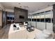 Bright living room with a fireplace, sleek furniture, and panoramic views of the surrounding mountains at 621 Majestic Rim Dr, Henderson, NV 89012