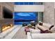 Contemporary living room with a fireplace, comfortable seating, and stunning views of the city skyline at 621 Majestic Rim Dr, Henderson, NV 89012