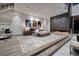 Modern bedroom with a gray fireplace accent wall, contemporary decor, and city views from the window at 621 Majestic Rim Dr, Henderson, NV 89012