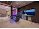 Modern outdoor kitchen with granite countertops, stainless steel grill, and a view of the mountains at 621 Majestic Rim Dr, Henderson, NV 89012