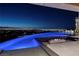 Stunning infinity pool with integrated fire feature and city views at 621 Majestic Rim Dr, Henderson, NV 89012