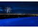 Infinity pool reflecting vibrant city lights at night, offering a serene and luxurious experience at 621 Majestic Rim Dr, Henderson, NV 89012
