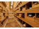 Well-organized wine cellar featuring custom wooden shelving and ample storage for wine bottles and cases at 621 Majestic Rim Dr, Henderson, NV 89012