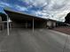 Single-story home featuring a covered carport, a large driveway, and a lawn at 6241 Factor Ave, Las Vegas, NV 89107