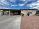 Single-story home featuring a covered carport, tidy landscaping, and a welcoming facade at 6241 Factor Ave, Las Vegas, NV 89107