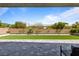 Backyard space with green lawn, brick wall and mature landscaping at 6270 Lamont Hills Ave, Las Vegas, NV 89139