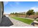 Landscaped backyard with pavers, a lawn, and privacy wall at 6270 Lamont Hills Ave, Las Vegas, NV 89139