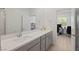 Bright bathroom with double sink vanity and a view of the adjacent office space at 6270 Lamont Hills Ave, Las Vegas, NV 89139