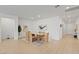 Bright dining room featuring a wooden table with seating for six, modern art, and neutral decor throughout at 6270 Lamont Hills Ave, Las Vegas, NV 89139