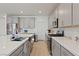 Modern kitchen with stainless steel appliances, sleek gray cabinets, subway tile backsplash, and quartz countertops at 6270 Lamont Hills Ave, Las Vegas, NV 89139