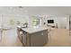 Bright, open-concept kitchen with an island that features a sink and quartz countertops, blending seamlessly into the living area at 6270 Lamont Hills Ave, Las Vegas, NV 89139