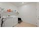 Functional laundry room featuring washer, dryer, and ample shelving at 6270 Lamont Hills Ave, Las Vegas, NV 89139