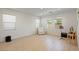 Bright living room with wood floors, large windows, and a comfortable chair at 6270 Lamont Hills Ave, Las Vegas, NV 89139