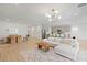 Open concept living space features dining table, chairs, modern light fixture, sofa, and kitchen island at 6270 Lamont Hills Ave, Las Vegas, NV 89139