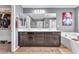 Bathroom featuring double vanity, large mirror, soaking tub, and walk-in closet at 6379 Dundock Ave, Las Vegas, NV 89122