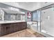 Bathroom boasting a shower with glass door, soaking tub, and double vanity sinks with counter space at 6379 Dundock Ave, Las Vegas, NV 89122