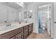 Bathroom with double sink vanity, tile flooring, and access to a toilet and shower area at 6379 Dundock Ave, Las Vegas, NV 89122