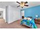 Bedroom featuring a blue accent wall, bed, closet and ceiling fan at 6379 Dundock Ave, Las Vegas, NV 89122