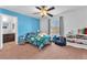 bedroom with blue accent wall, bed, and a view into the connected bathroom at 6379 Dundock Ave, Las Vegas, NV 89122
