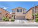 Charming two-story home featuring a two-car garage and a welcoming entrance at 6379 Dundock Ave, Las Vegas, NV 89122